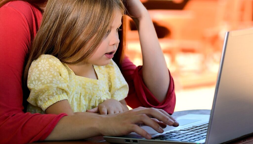 A child participating in speech therapy with a computer.