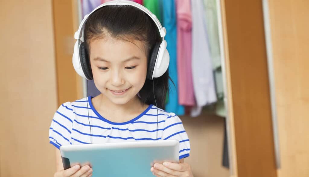 A girl participates in speech therapy treatment using an iPAD.