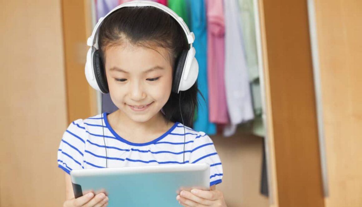 A girl participates in speech therapy treatment using an iPAD.