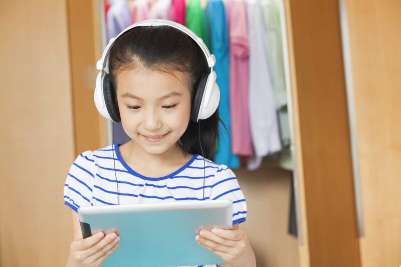 A girl participates in speech therapy treatment using an iPAD.