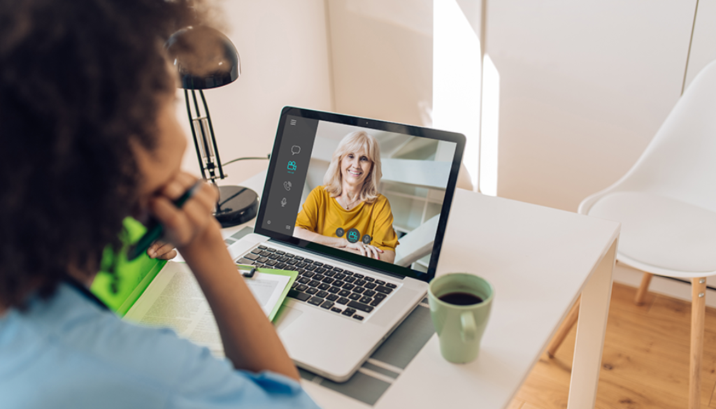 A parent speaking to a speech therapist through a virtual session on the computer.