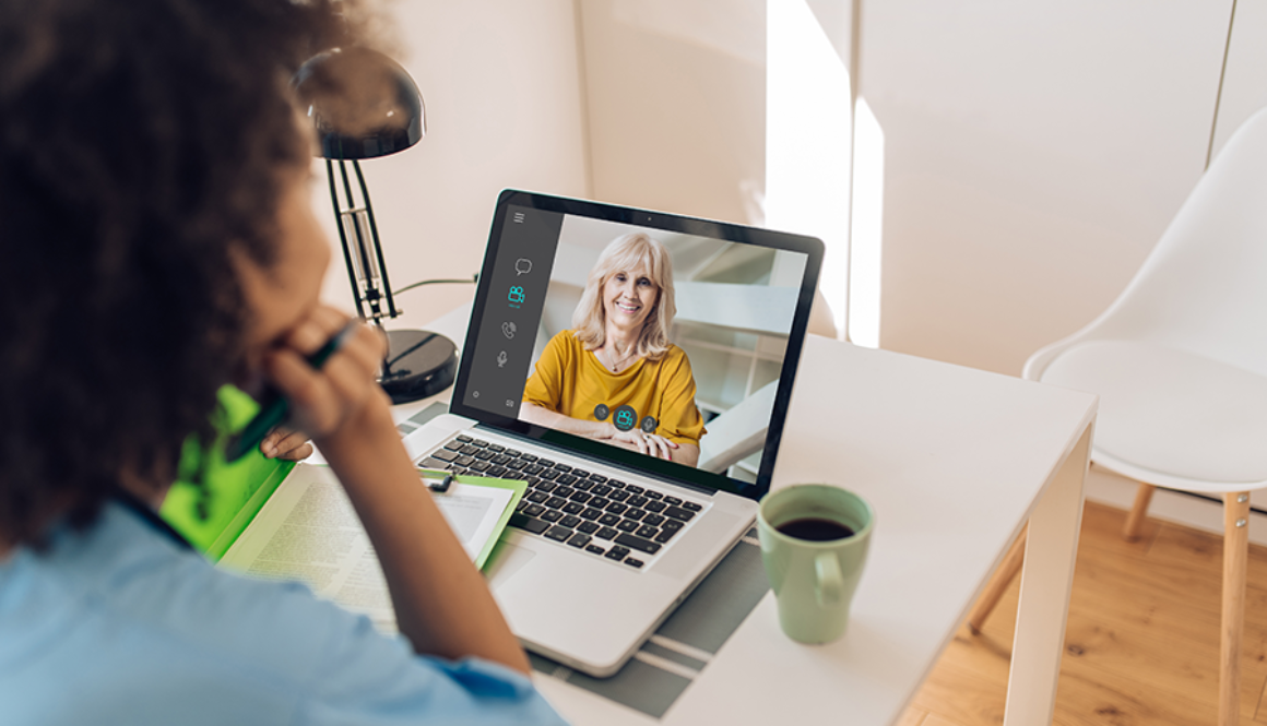 A parent speaking to a speech therapist through a virtual session on the computer.