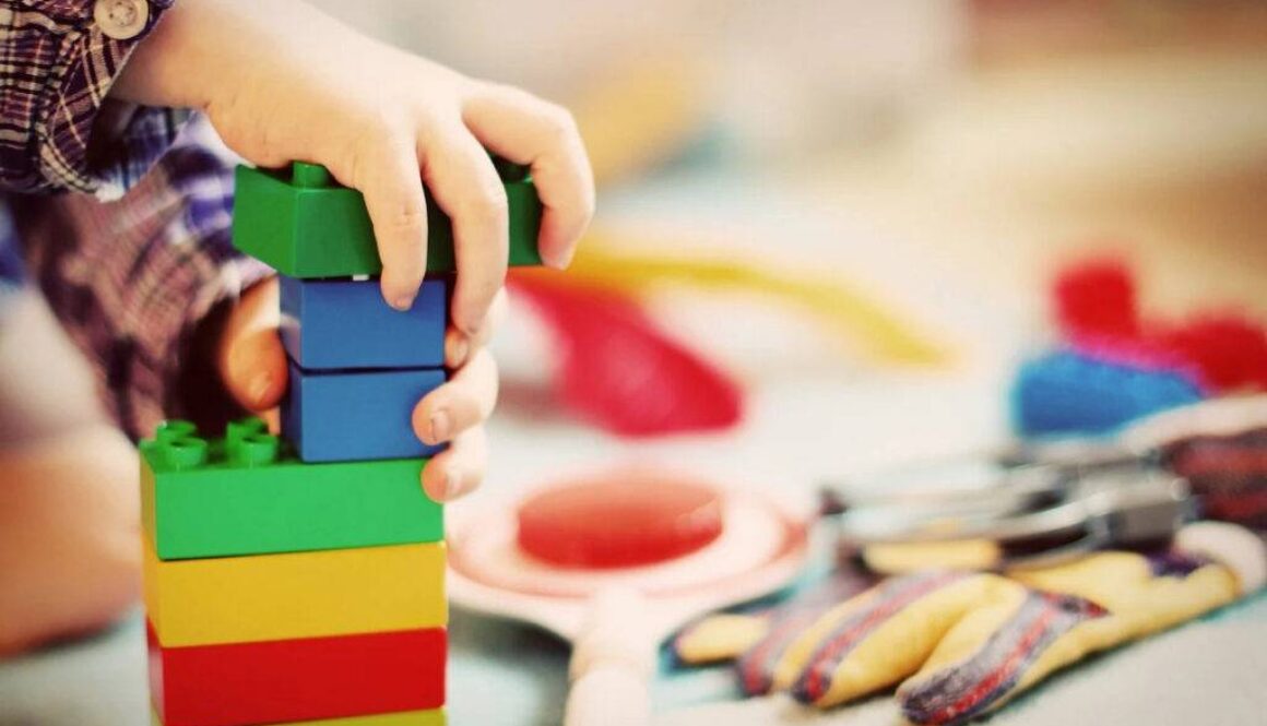 A child plays with blocks during speech therapy.