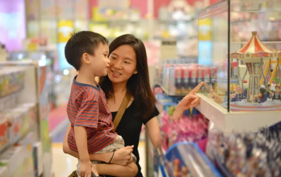 A mother uses her child's speech therapist tips in the community.