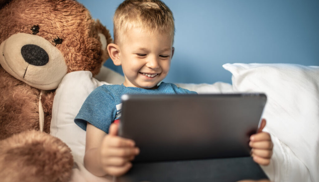 A child participating in articulation therapy at home using an iPAD.