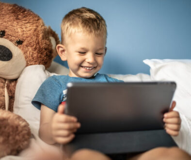 A child participating in articulation therapy at home using an iPAD.