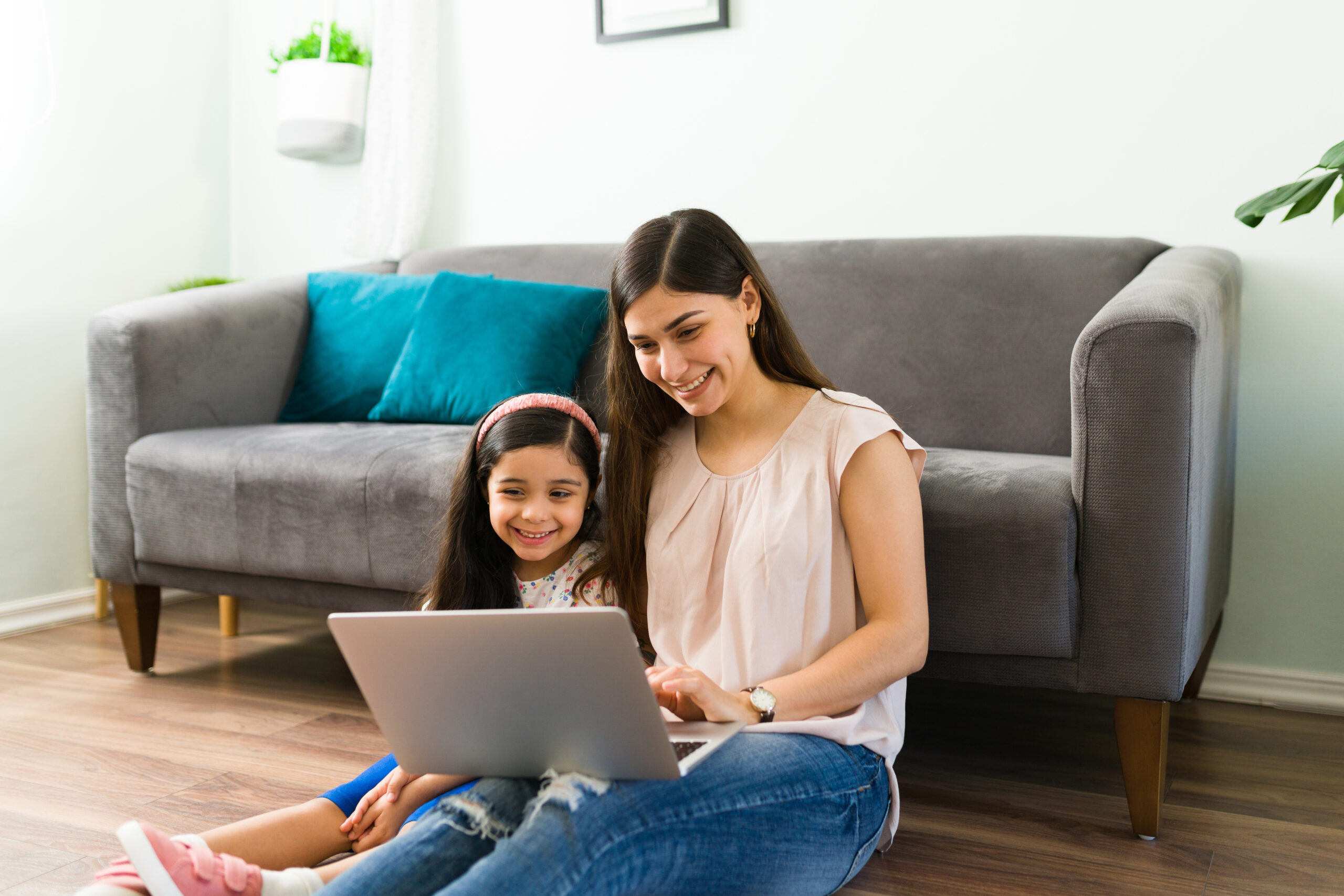 A mother and child participating in online speech therapy.