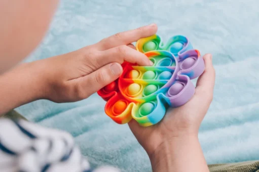 A child with autism playing with a widget toy.