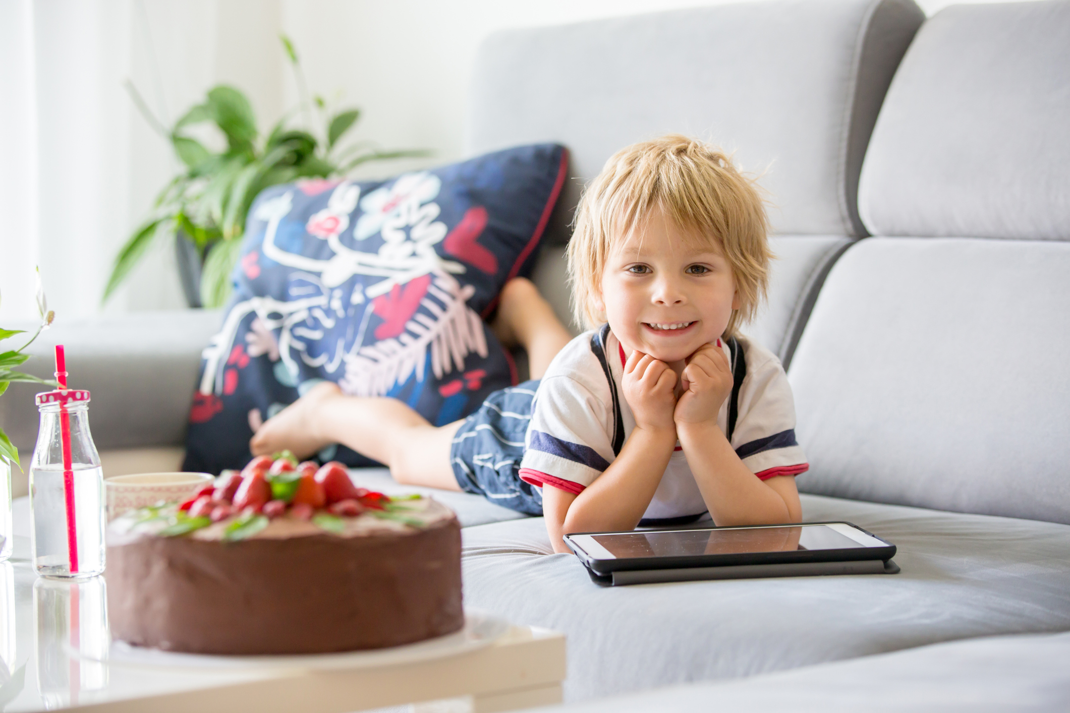A child getting speech therapy sessions on his iPAD at home.