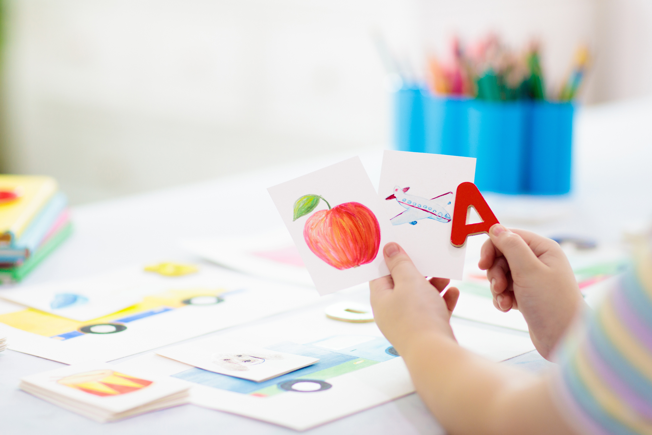 A child playing and practicing words during early language learning.