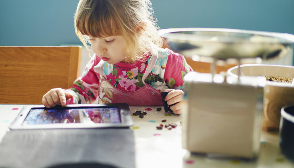 Curious girl using digital tablet
