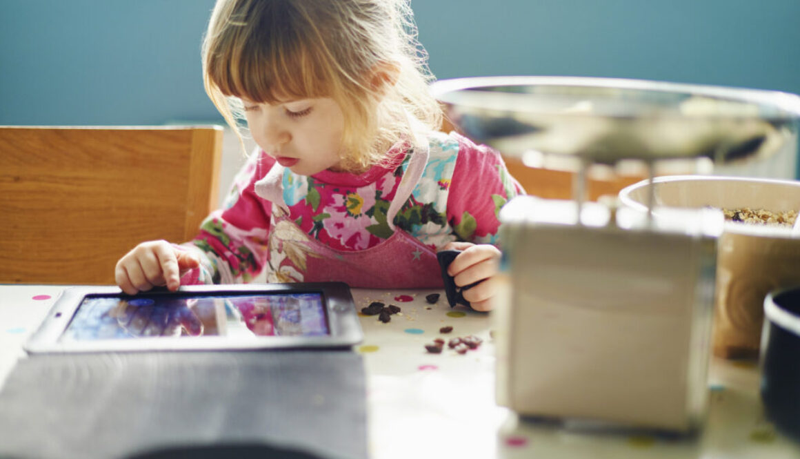 Curious girl using digital tablet