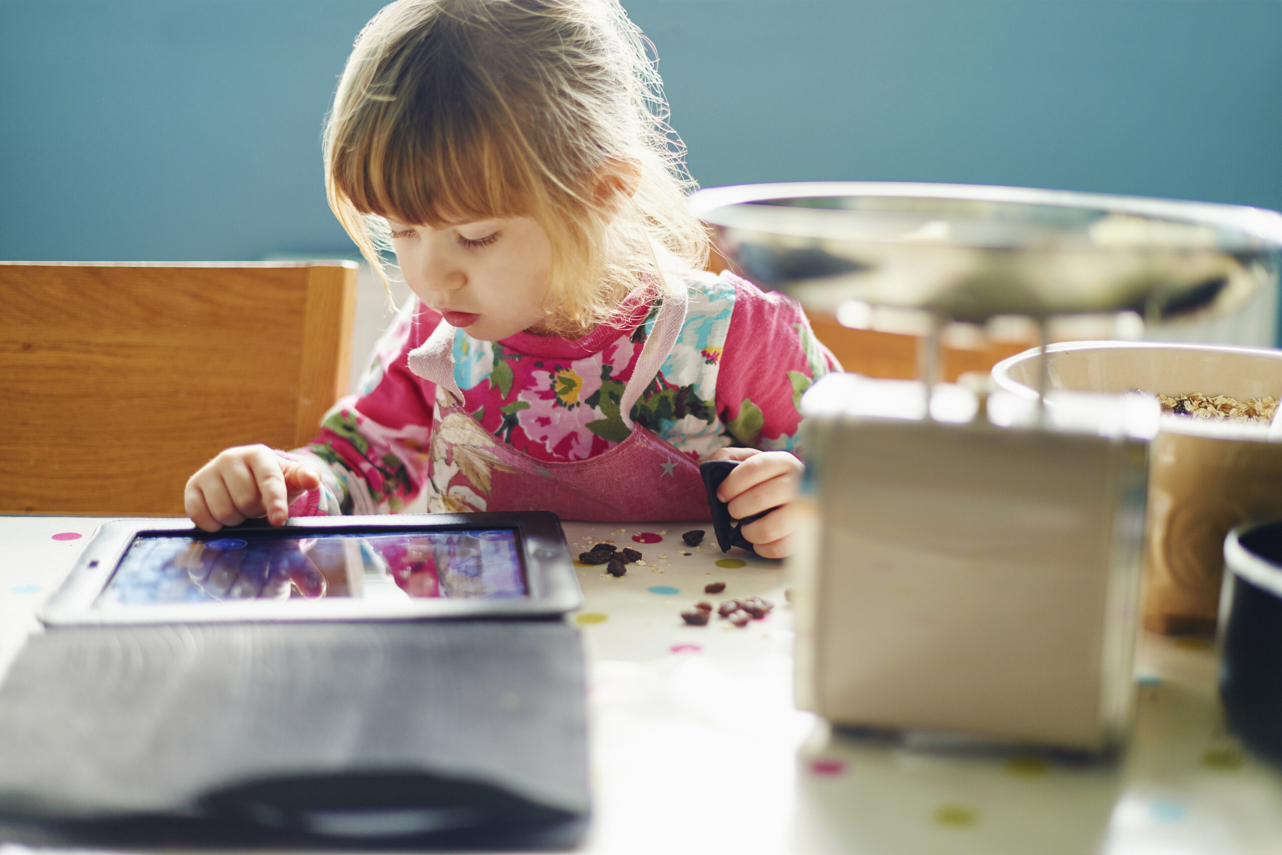 Curious girl using digital tablet