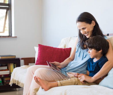 A mother practicing better language skills with her son using iPAD games.