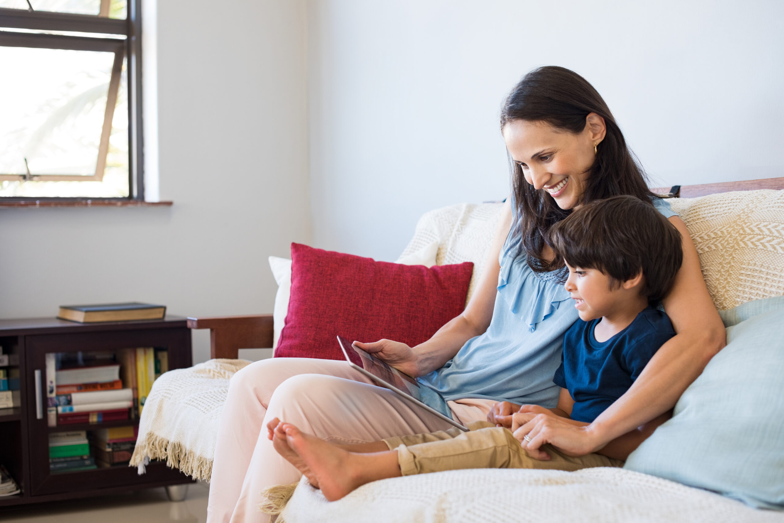 A mother practicing better language skills with her son using iPAD games.