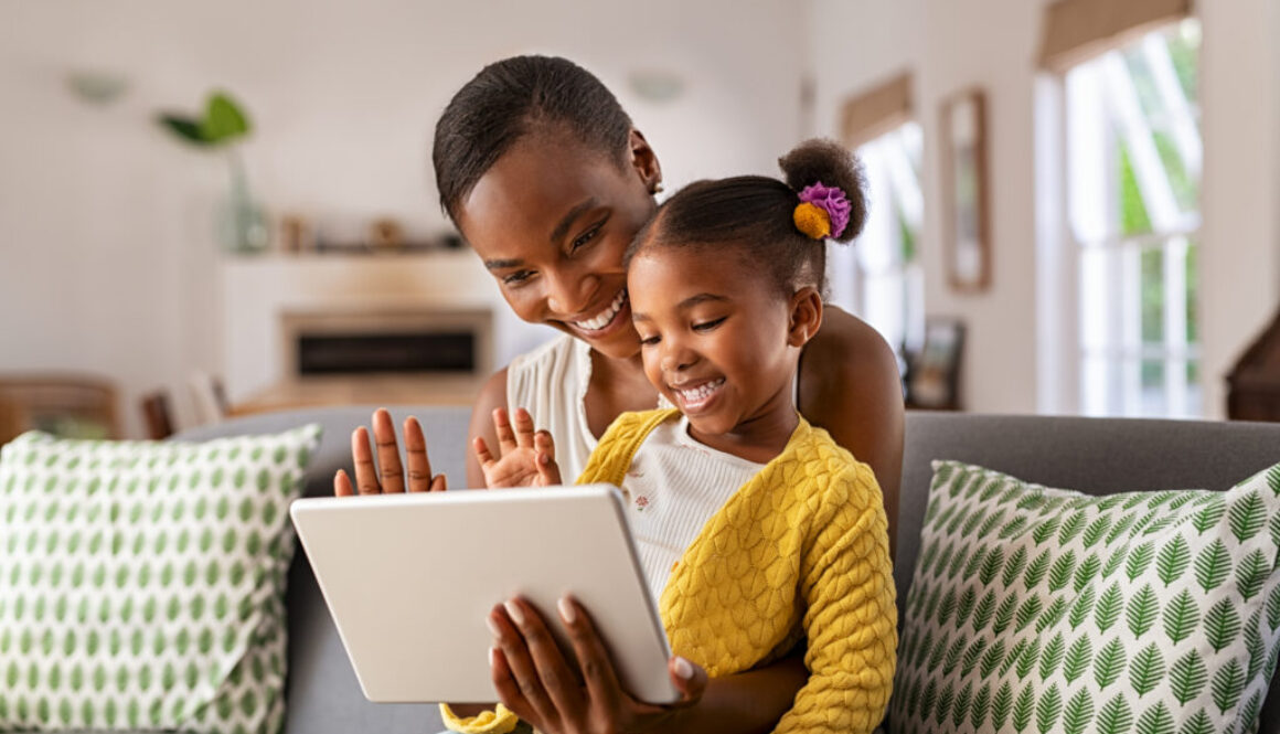 A parent supporting her child during speech therapy at home