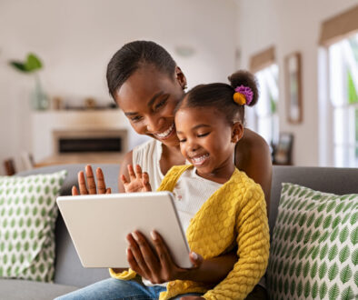A parent supporting her child during speech therapy at home