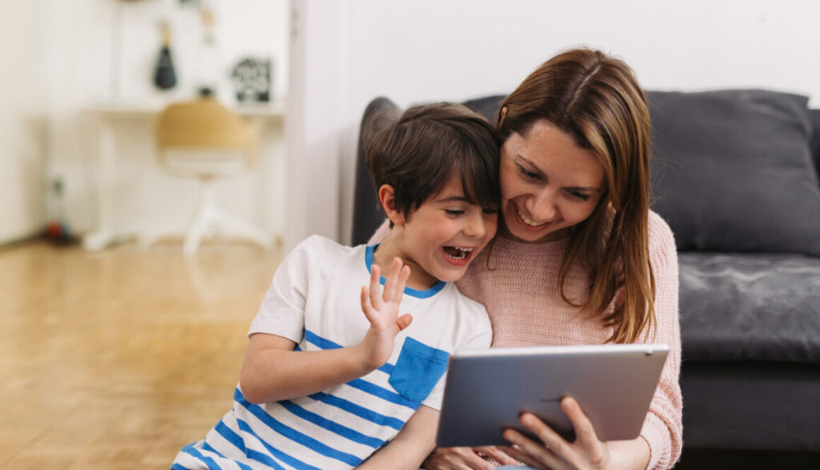 A mother and child talking to a speech therapist on their iPAD to get speech help
